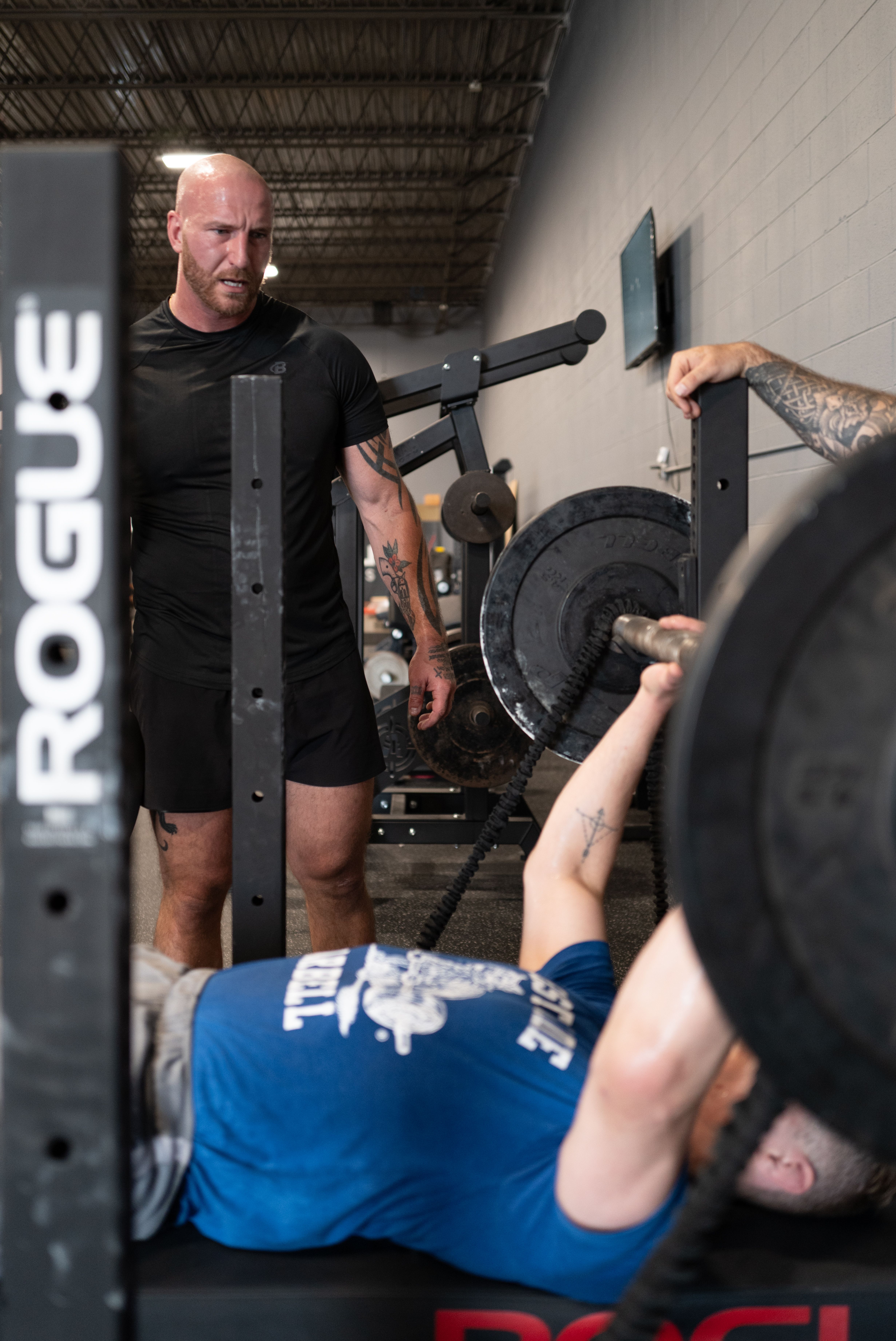 Craig Bongelli spotting a client on the bench press at Westside Barbell