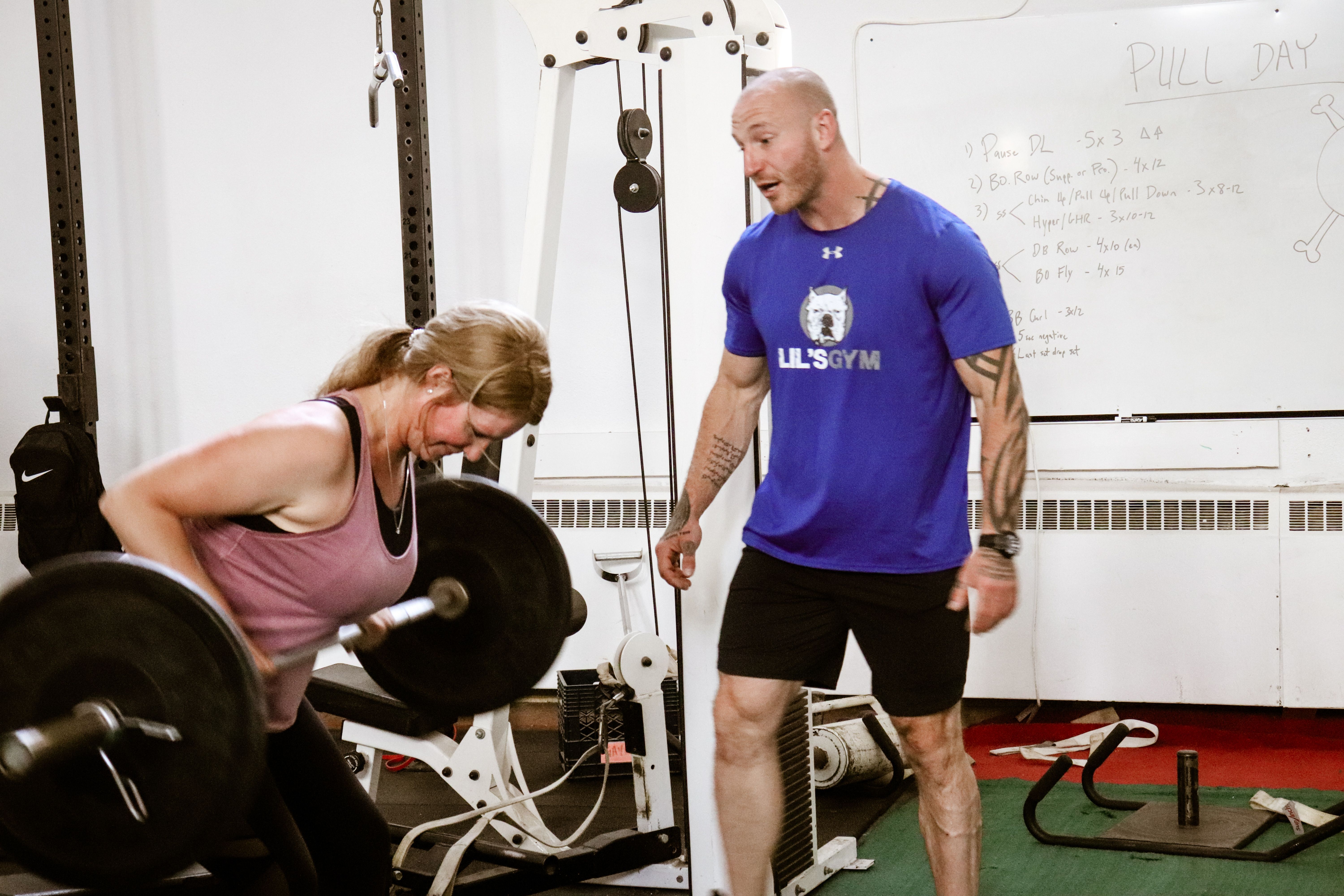Craig Bongelli coaching a client through a barbell row