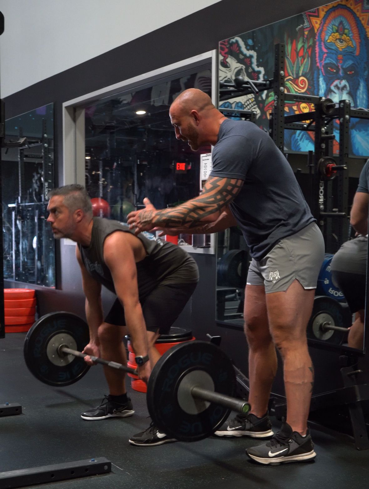 Craig Bongelli coaching a client through a deadlift